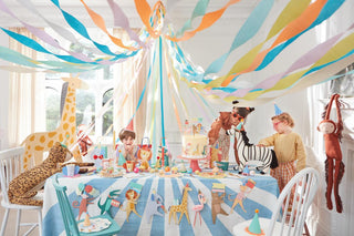 A joyful children's birthday party with a table adorned in pastel streamers and animal decorations, as kids in animal masks celebrate with cake and crafts in a brightly lit room.