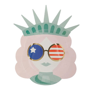 Illustration of a stylized female face representing Lady Liberty Shaped Paper Plates by My Mind's Eye, adorned with sunglasses featuring American flag motifs on the lenses.