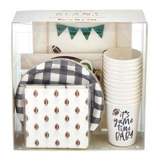 A "Football Party in a Box - Tailgate" set by Slant, including black and white patterned plates, cups with "it's game time baby" text, napkins with football prints, and a festive