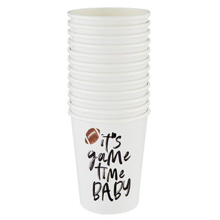 A stack of white disposable cups, part of our Football Party in a Box - Tailgate collection by Slant, with "it's game time baby" printed on one, suggesting a fun, sports-themed event or party atmosphere.