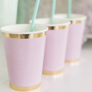 A set of Posh Lilac You Lots Cups from Jollity & Co, each adorned with a turquoise straw, arranged neatly on a soft-focus background.