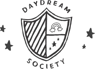 A shield-shaped emblem with diagonal stripes on the left, a rainbow with clouds on the top right, and three stars on the bottom right, encircled by the words "Daydream Society.