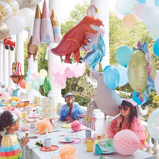 A vibrant children's birthday party with a dinosaur theme, featuring an array of colorful balloons, a large dinosaur centerpiece, and themed decorations on the table as kids engage happily with the festive surroundings.