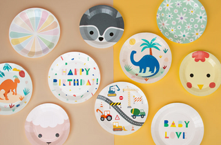 A colorful assortment of whimsical paper plates with various designs including animals, vehicles, and a "happy birthday" message, suitable for festive celebrations like birthdays and baby showers.