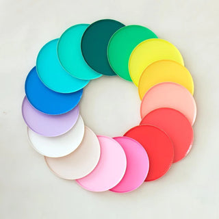 A circle of various colored discs creating a gradient from violet to red, showcasing a spectrum resembling a color wheel against a pale background.