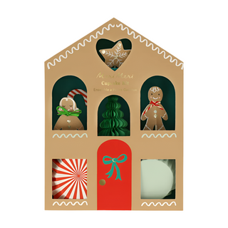 Meri Meri's Gingerbread Cupcake Kit includes charming toppers such as gingerbread figures, candy canes, and green trees, along with cupcake liners elegantly showcased in window cutouts—an imaginative gift for holiday baking enjoyment.