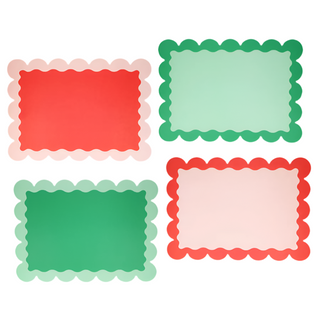 Four rectangular Christmas Paper Placemats by Meri Meri, featuring scalloped edges and diverse color combinations: red with light pink, light green with dark green, dark green with light green, and pink with red. These modern twist placemats bring a festive flair to your Christmas table.