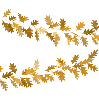 Meri Meri’s Gold Oak Leaves Garland, crafted from shimmering gold foil, is arranged in two horizontal lines against a crisp white background. It’s the perfect addition to elevate your Thanksgiving decor with elegance.