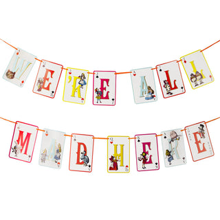 The "Alice in Wonderland Multi Colored Double Sided Bunting" by Talking Tables features playful fonts spelling "WE'RE ALL MAD HERE" on colorful cards adorned with whimsical illustrations from Alice in Wonderland, making it a perfect decoration for your next tea party.