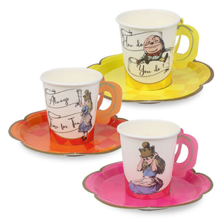 Three paper cups featuring illustrated characters and text, each on bright-colored scalloped paper plates: a yellow plate with a Humpty Dumpty cup, a red plate with an Alice cup from the Alice in Wonderland Bright Tea Cup Set by Talking Tables, and a pink plate with a Queen cup.