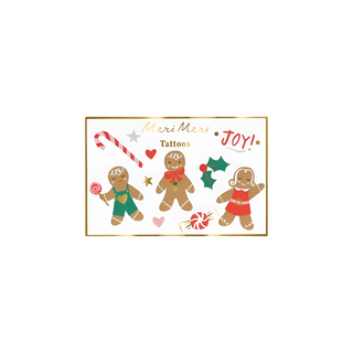 Image of festive Christmas temporary tattoos from the "Meri Meri" brand, featuring gingerbread people, a candy cane, lollipops, stars, holly, and the word "Joy!" These Gingerbread Temporary Tattoos are perfect for holiday party favors!