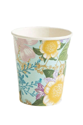 The Botanical Paper Cups by We Love Sundays feature a charming floral design with yellow, pink, and purple dahlias interwoven with green foliage set against a light blue background.