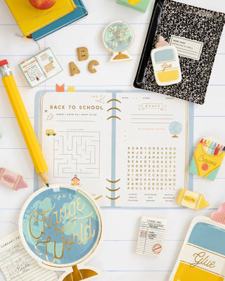 A collection of school-themed items including a notebook labeled "Back to School," cookies in shapes like pencils and notebooks, My Mind’s Eye Composition Notebook Plate, erasers, pencil eraser toppers, and motivational quote decor.