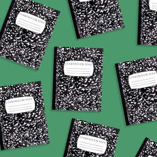 Several black-and-white speckled composition books are arranged on a green background, each with a white label on the cover. A few Back To School Composition Notebook Party Punchies by Cami Monet add a splash of color to the scene.