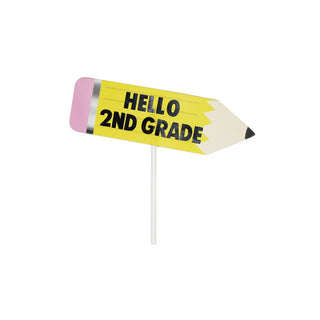 The Merrilulu Back To School Custom Cake Topper features a pencil-shaped sign with "HELLO 2ND GRADE" inscribed on it, attached to a white stick—ideal for personalizing cake decorations at a back-to-school celebration.