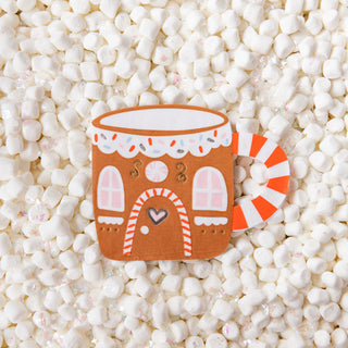 Daydream Society's Baking Spirits Bright Gingerbread House Mug Large Napkins are ideal for spreading holiday cheer, featuring a charming gingerbread house design resting on a bed of mini marshmallows.