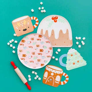 Festive flat lay with Daydream Society's Baking Spirits Bright Gingerbread House Mug Large Napkins, a rolling pin, and scattered mini marshmallows on a teal background, perfectly capturing the essence of a cookie decorating party filled with holiday cheer.