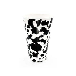 A disposable paper cup adorned with a black and white cowhide print pattern, isolated on a white background, embodying a playful design twist on everyday drinkware. Perfect for farm-themed birthday parties. 
Introducing the Party West Black Cowhide Cups.