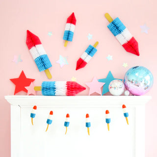 Celebrate the 4th of July with these festive Bomb Rocket Pop Honeycomb Popsicles adorned with glitter sticks and honeycomb tissue paper from Kailo Chic!
