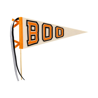 The Boo Felt Pennant Banner by My Mind’s Eye features a triangular pennant with "BOO" boldly displayed in orange letters, ideal for your Halloween festivities. Adorned with two black and white ribbons on the left side, this banner adds a delightful touch to your Halloween decor.