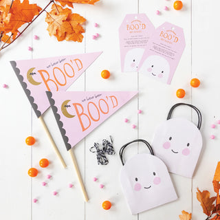 The Halloween Boo'd Kit by My Mind's Eye, with its paper ghost bags, "BOO'D" pennants, orange candies, and leaves arranged on a white surface, beautifully captures the spooky joy of the Halloween spirit.