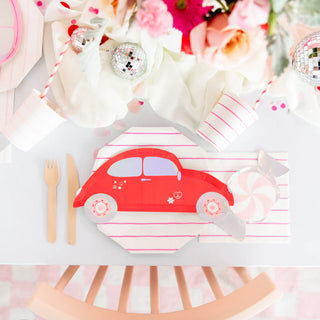 For a delightful table setting perfect for Valentine's Day, feature the charming Buggy of Love Small Plates by Daydream Society, accompanied by wooden cutlery, pink-striped napkins and cups, and elegant floral decor. The addition of holographic silver foil accents introduces a touch of sparkle to the ensemble.