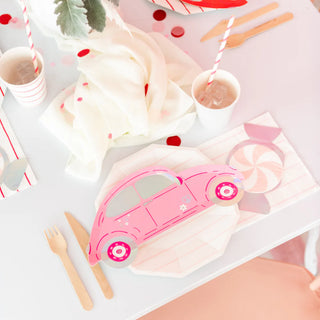 The table is arranged for a party with whimsical Buggy of Love Small Plates by Daydream Society, complemented by striped straws, drinks, wooden utensils, and festive decorations. Accents of holographic silver foil add a touch of magic to the scene. Perfect for celebrating Valentine's Day in style!