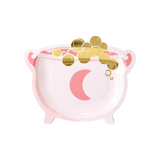 The My Mind’s Eye Cauldron Shaped Plate features a white and pink design with a crescent moon and gold bubbles on top, making it perfect for serving spooky snacks at your Halloween party.