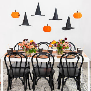 A Halloween table setting with pumpkins and witches hats, complete with Check It! Halloween Dessert Plates and napkins from Jollity & Co.