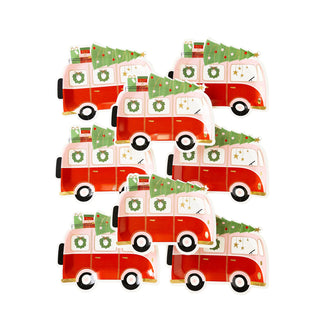 A group of festive red and white My Mind's Eye VW camper vans adorned with Christmas trees.