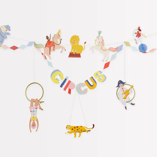 A whimsical Meri Meri Circus Garland decoration featuring illustrated animals and acrobats performing, with the word "circus" boldly displayed in the center.