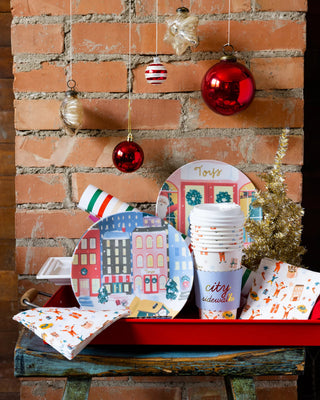 A red tray with My Mind's Eye City Sidewalks Cocktail Napkin and ornaments, perfect for holiday parties.