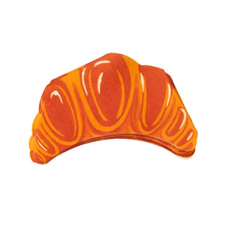 A **Croissant Die Cut Napkin** designed to look like a croissant, with orange and brown tones, showcases Parisian charm against a white background. **Paper Source**