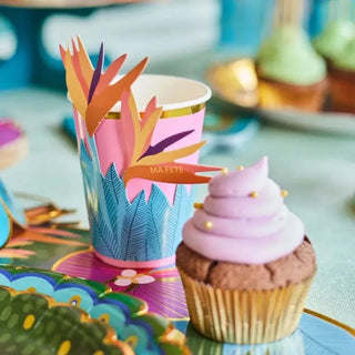 A colorful table setting with Tropical Cups with Flower Sleeves and gold rims from Ma Fête.