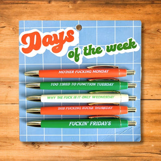 The Fun Club's Days of the Week Pen Set includes five black ink ballpoint pens, each labeled with a humorous phrase representing Monday through Friday. These organized pens come packaged on a card titled "Days of the Week," turning writing into a fun daily routine.