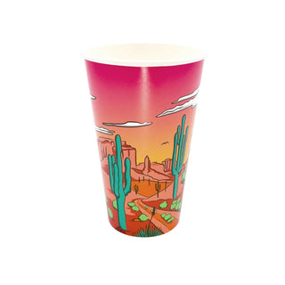 A disposable paper cup featuring a vibrant desert sunset scene with silhouettes of cacti and mesa landforms under a gradient sky of pink and orange hues, perfect for a bachelorette party - Desert Scene Cups by Party West