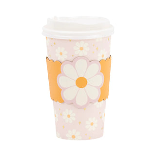 A pink disposable cup with a white lid and a floral design. The Disco Daisy To Go Cups by My Mind’s Eye feature a yellow and white daisy pattern, with a larger daisy on an orange sleeve around the middle. Perfect for any occasion, these stylish party cups bring cheer to your gatherings.