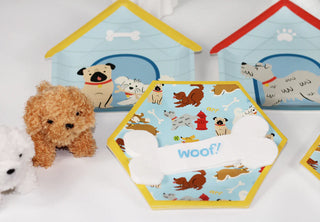 Plush toy dogs come with toy doghouses and feature hexagonal cards displaying "Woof!" on bone-shaped cutouts surrounded by cartoon dog illustrations, perfect for adding a fun touch to puppy lover's birthday parties. For an extra special detail, consider using Merrilulu's Dog Bone Shaped Napkins.