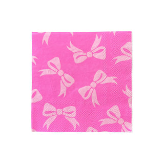 A paper napkin with a pattern of white bows in pink from the Eloise Petite Napkins by Daydream Society.