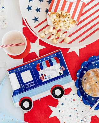 Celebrate the Fourth of July with delicious treats from a festive food truck decked out in holographic foil accents. Serve up your favorite dishes on My Mind's Eye Firework Truck Shaped Plates for the perfect patriotic touch.