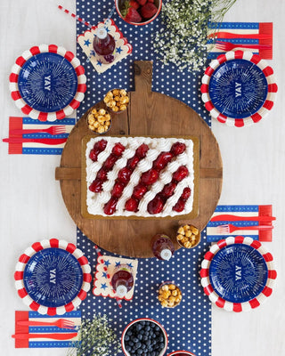 Patriotic Fourth of July table setting with red, white and blue decorations. Featuring Firework Yay Plates by My Mind's Eye.