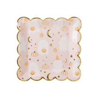 The Ghost Scatter Plate by My Mind’s Eye is a pink square plate with scalloped edges, featuring a pattern of white ghosts, orange pumpkins, stars, and crescent moons. Adorned with gold foil accents, it's perfect for adding a ghostly touch to your Halloween party.