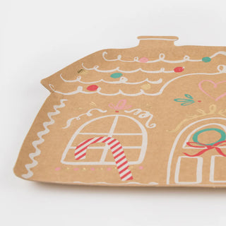 Introducing the Meri Meri Gingerbread House Plates, adorned with drawn decorations featuring candy canes and abstract holiday designs, perfect for your Christmas party.