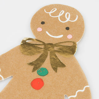 Detailed illustration of a gingerbread man featuring a smiling face, white icing details, three colorful buttons, and a gold bow tie. Perfect for Christmas party invitations or adding charm to Meri Meri's Gingerbread Napkins adorned with elegant gold foil details.