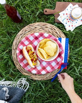 A hot dog and chips on a picnic basket with My Mind’s Eye Gold Foiled Lots of Stars Cocktail Napkin.