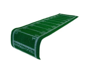 A long green mat designed to resemble a football field, with yard lines and numbers marked along its length, perfect as the Grass Football Table Runner by Talking Tables for your next Super Bowl party.