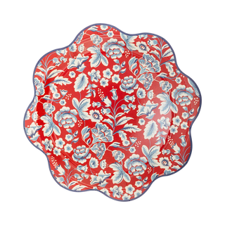 A decorative floral pattern on a scalloped-edge shape with a vibrant red background and multiple shades of blue flowers interspersed with white, placed over a striped black and white surface. Ideal for outdoor gatherings with its durable paper plate design, this My Mind’s Eye HAMPTONS FLORAL WAVE PAPER PLATE collection adds style to any event.