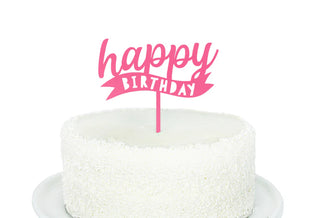 A delightful white cake with textured frosting on a white plate, adorned with the "Happy Birthday Pink Acrylic Topper" by Merrilulu—an ideal choice for any birthday celebration.