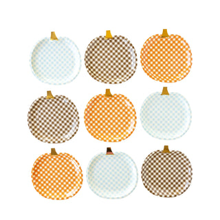 A perfect addition to your Thanksgiving table decor, the Harvest Gingham Pumpkin Shaped Paper Plate Set by My Mind’s Eye features a grid of nine plates with checkered patterns in brown, orange, and light blue, all arranged in rows and columns against a white background.