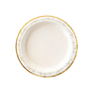 The Harvest Words Charger Plate by My Mind’s Eye is a white round paper plate featuring gold foil edging and elegant gold script with the words "thankful" and "grateful" around the border; perfect for an elegant Thanksgiving dinner tablescape.